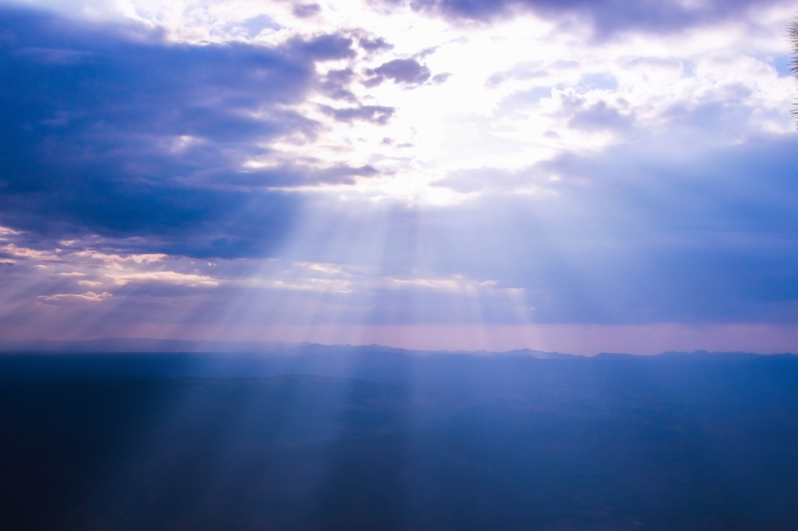 Sunbeam through clouds on blue sky